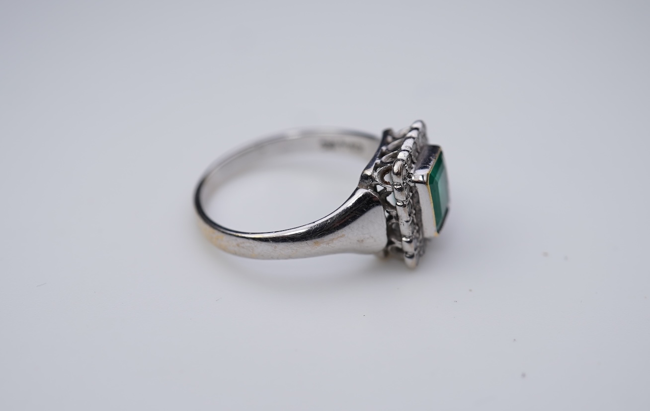 An emerald and diamond ring